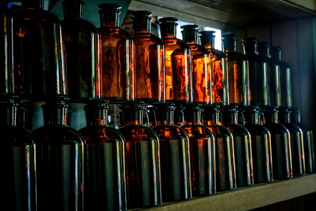 A row of glass bottles on a shelf